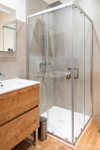 a shower with a glass door in a bathroom at Croix Paquet - Appartements à Lyon in Lyon