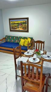 a living room with a table and a couch at Condomínio Golden Dolphin Village in Porto Seguro