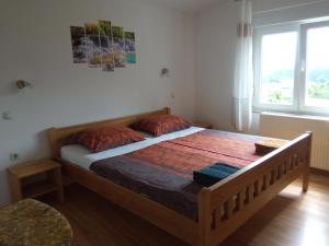a bed in a room with a large window at KATY&MLADEN in Baška +34 photos