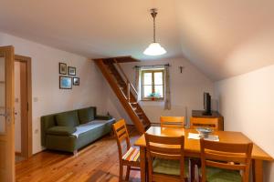 a living room with a table and a couch at Mala hiša in Solčava