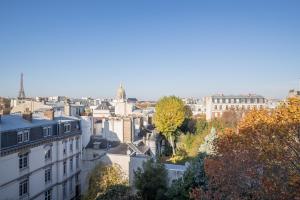 a view of a city with buildings and trees at Eiffel Tower view terrace Saint Germain des Pres in Paris