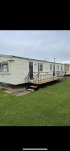 a large white building with a ramp in a field at S452 Golden Palm Resort in Chapel Saint Leonards