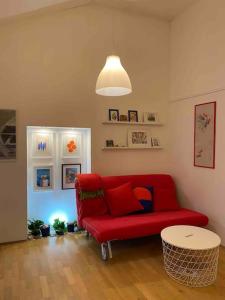 a living room with a red couch and a table at MODERN APARTMENT IN THE HEART OF OLD TOWN in Rab