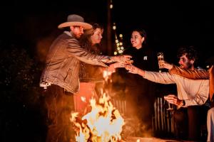 a group of people standing around a fire at TinyParks Cast Away in Zuid-Beijerland