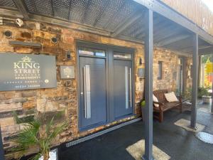 a brick building with a blue door on it at King Street Serviced Apartments in Lancaster