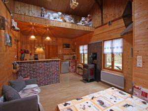 a kitchen and living room with wooden walls and wooden floors at Gîte Plainfaing, 3 pièces, 4 personnes - FR-1-589-306 in Plainfaing