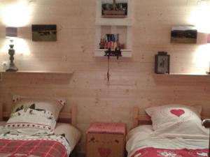 two twin beds in a room with wooden walls at Gîte Plainfaing, 3 pièces, 4 personnes - FR-1-589-306 in Plainfaing