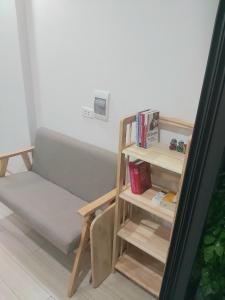 a living room with a couch and a book shelf at The mini apartment includes breakfast in Hanoi
