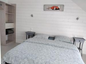 a bedroom with a bed and two night stands at Résidence des 14 Moulins in Pont-Aven