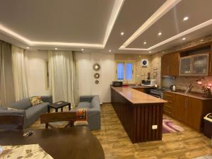 a kitchen and living room with a couch and a table at فيلا مميزه جدا في الساحل الشمالي ستيلا هايتس Stella Heights - Sidi Abd El-Rahman villa type M in El Alamein