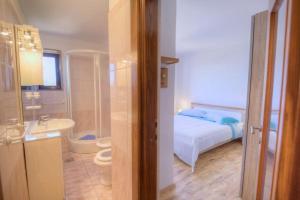 a bedroom with a bed and a bathroom with a toilet at Casa Cerin with Private Pool in Barat +12 photos