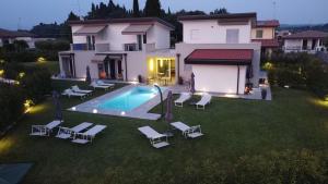 an aerial view of a house with a swimming pool and chairs at B&B Lough in Colà di Lazise