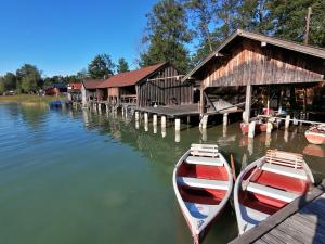 two boats sitting at a dock next to a building at Wunderschöne Ferienwohnung mit Seeblick in Zell am Moos