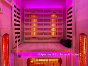 an empty room with purple lights on the wall at Serenity Apartments Bradford in Bradford