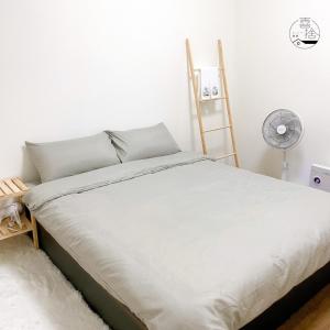Giường trong phòng chung tại Xishi Stay