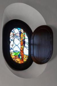 a round window with a stained glass window at Lis Fadis Wine Relais in Cividale del Friuli