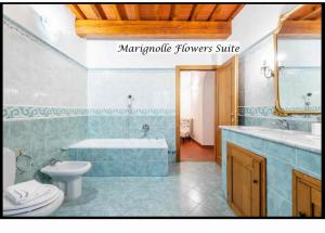 a bathroom with a tub and a toilet and a sink at Marignolle Flowers Suite in Florence