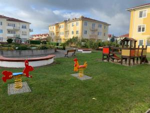 a playground with three toy animals in the grass at Apartament Nuldenovski Resort Grzybowo in Grzybowo