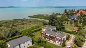 an aerial view of a house next to the water at Balatonic apartman in Zamárdi
