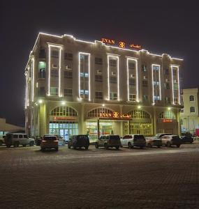 a large building with cars parked in front of it at Evan إيفان in Salalah