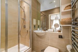 a bathroom with a shower and a toilet and a sink at Gorgeous Wembley Flat in London