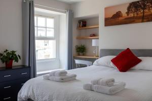 a bedroom with a bed with towels on it at River Views, Free Parking, Near Royal William Yard in Plymouth