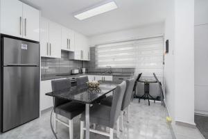 a kitchen with a table with chairs and a refrigerator at Villa Blue in Kyrenia