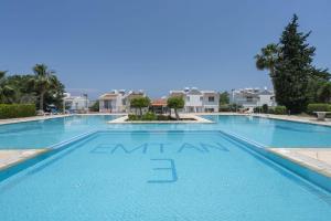 a large swimming pool with blue water at Villa Blue in Kyrenia