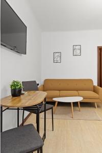 a living room with a couch and a table at Upscale Studio, Walking Distance from The Old Town in Bucharest