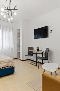 a bedroom with a bed and a table and chairs at Upscale Studio, Walking Distance from The Old Town in Bucharest