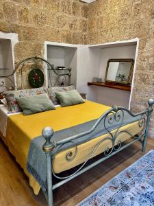 a bedroom with a bed in a stone wall at All’ombra del museo in Tarquinia