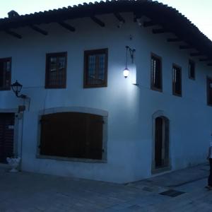 a white building with a light on the side of it at Rooms for Rent in Shkodër