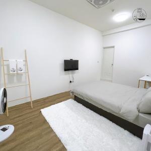 Giường trong phòng chung tại Xishi Stay