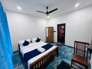 a bedroom with a bed and a ceiling fan at Golden cherry in Munnar
