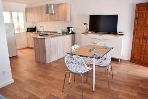 a kitchen with a table and chairs in a room at Casa Alex Torrevieja- Holiday House - con piscina comunitaria in Torrevieja