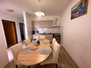 mesa de comedor con sillas y cocina en Apartment Lucija, en Zadar
