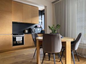a kitchen and dining room with a table and chairs at Kaupmehe Terrace Apartment, free parking in Tallinn