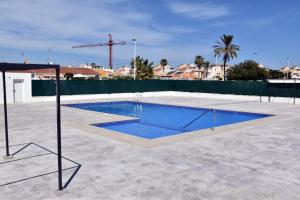 a swimming pool in the middle of a patio at Casa Alex Torrevieja- Holiday House - con piscina comunitaria in Torrevieja
