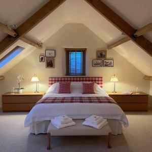 a bedroom with a large bed with two night stands at Yew Tree Cottage in Shepton Mallet