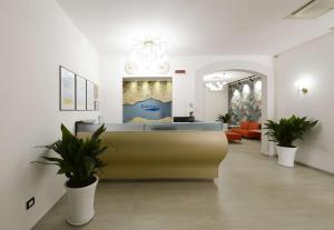 a lobby with a waiting room with potted plants at Best Western Hotel Martello in Lampedusa
