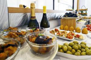 a table with plates of food and bottles of wine at Best Western Hotel Martello in Lampedusa
