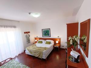 a hotel room with a bed and a window at Best Western Hotel Martello in Lampedusa