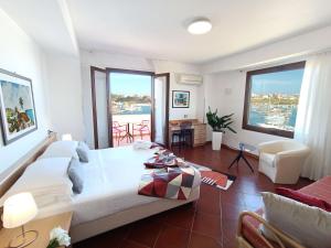 a bedroom with a large bed and large windows at Best Western Hotel Martello in Lampedusa