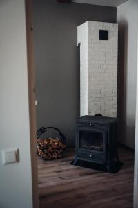a black stove in a room with a fireplace at Stylish and cozy old town apartment in Võru
