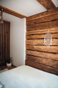 a bedroom with a wooden wall with a bed at Stylish and cozy old town apartment in Võru