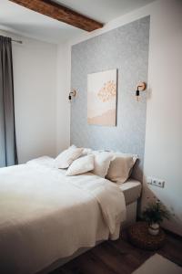 a bedroom with a large bed with white sheets at Stylish and cozy old town apartment in Võru