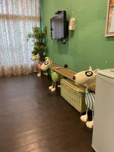 a room with three stuffed animals in a room at House Lane 123 in Tainan