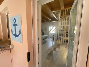 an open door to a room with an anchor on the wall at Casa Lo Chef - ArgonautiVacanze in Portoferraio