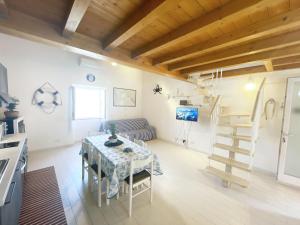 a kitchen and living room with a table and a ladder at Casa Lo Chef - ArgonautiVacanze in Portoferraio