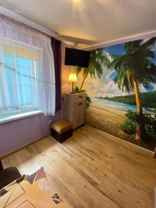 a room with a palm tree mural on the wall at Dom rodzinny in Władysławowo